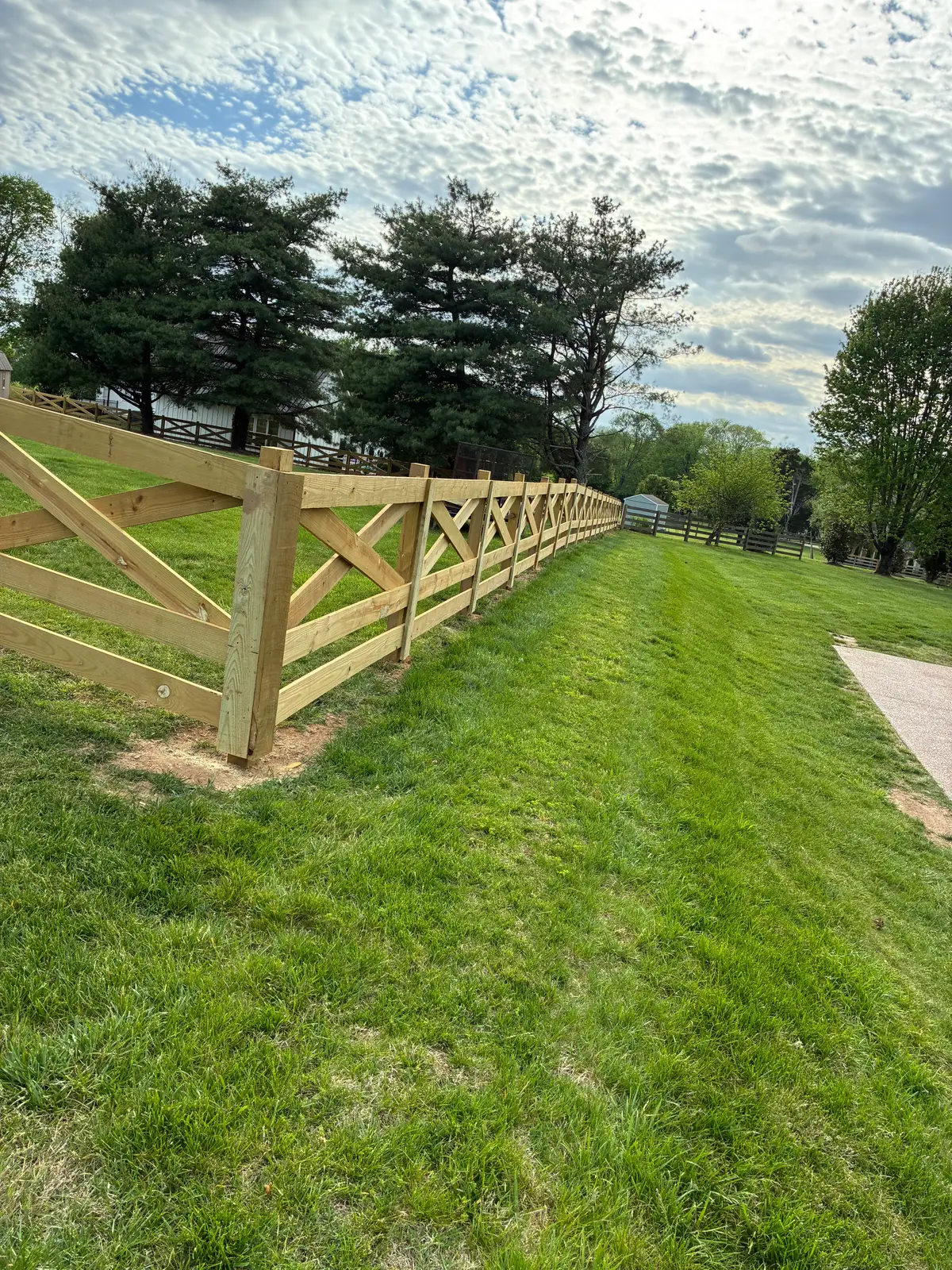 Wood X-brace fence long perspective, installed by Duck Duck Fence