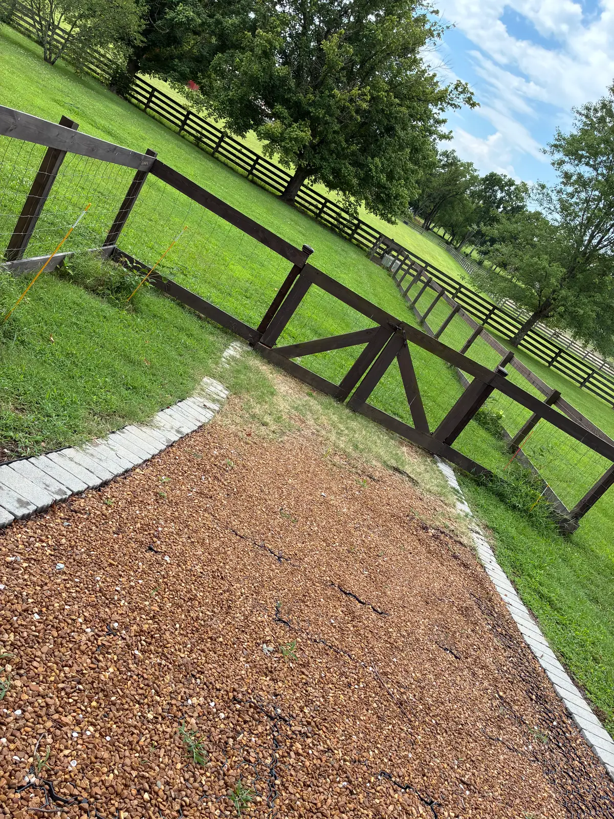 Black X-brace ranch fence slope, installed by Duck Duck Fence