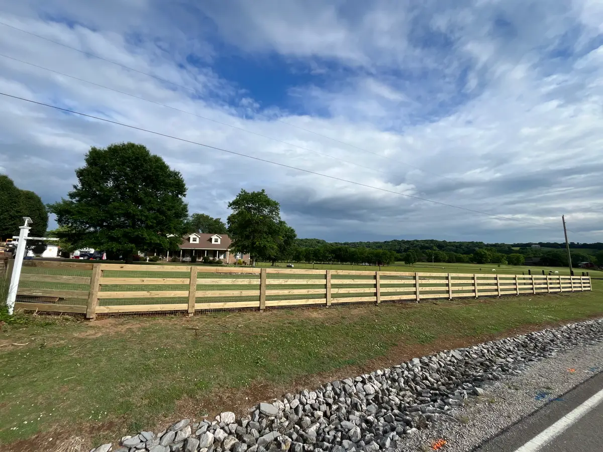 Wood rail fence with gravel landscaping, installed by Duck Duck Fence